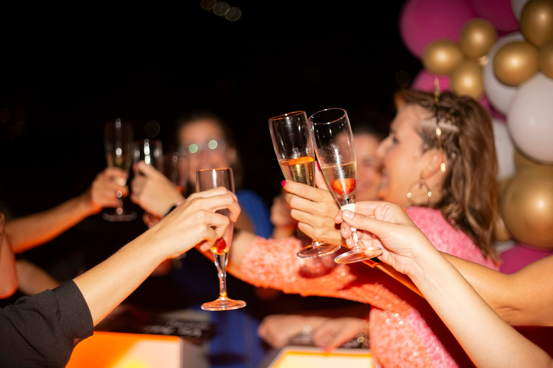 a group of people holding glasses of wine