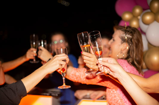 a group of people holding glasses of wine