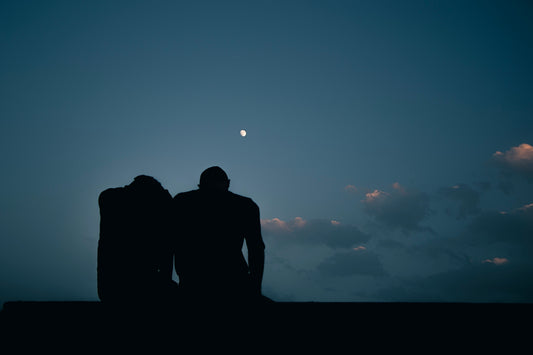 a couple of people sitting on top of a roof
