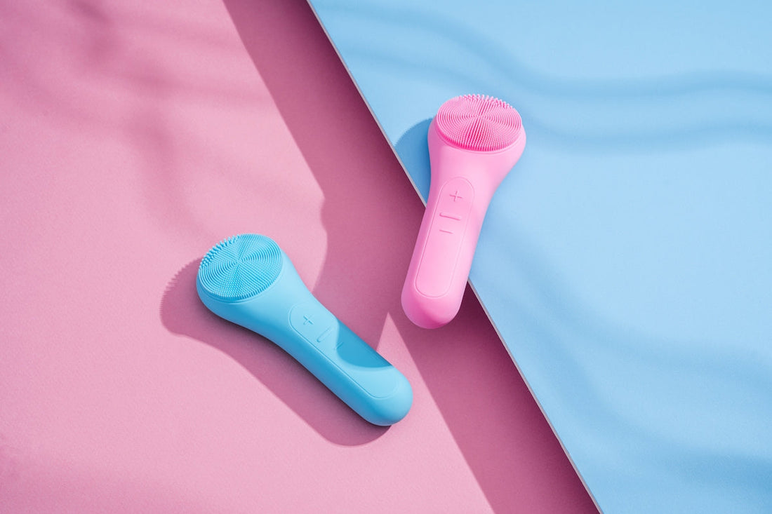 a pink and a blue hair brush on a pink and blue surface