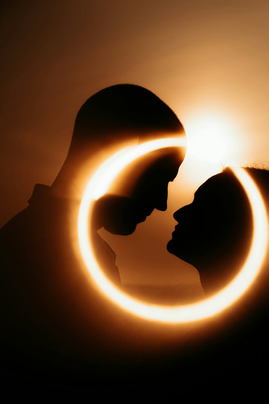 Silhouettes of a couple framed by a glowing circle
