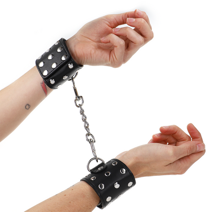 KINK - WRIST RESTRAINTS WITH SNAP FASTEN FULL OF RIVETS BLACK ADJUSTABLE 19-24 CM X 5.5 CM - My naughty haven #